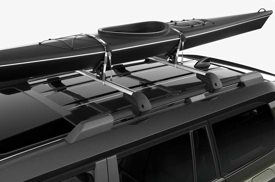 Close-up shot of Lexus GX roof carrying a kayak with optional kayak carrier accessory. 