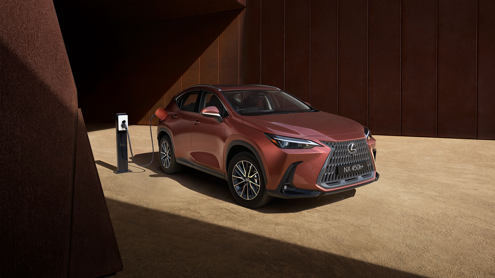 Lexus NX 450h+ charging on a gravel driveway